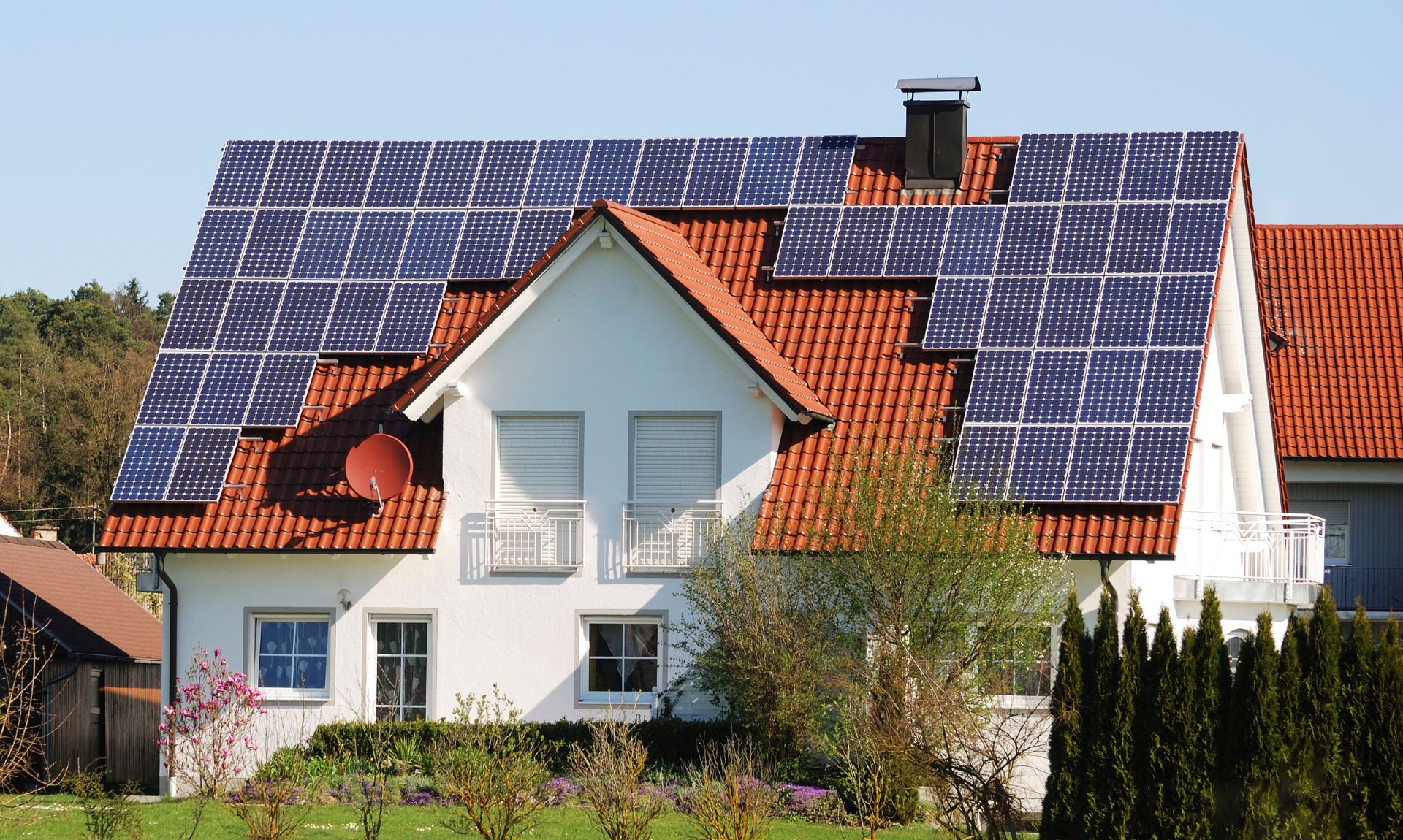 Ein Einfamilienhaus mit Photovoltaik Anlage auf dem Dach hilft beim Strom sparen.